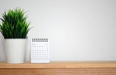 July Calendar 2023 on table background.Time planning, day counting and holidays