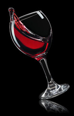 glass of red wine with splash isolated on black