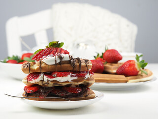 Breakfast with american waffles and fresh strawberries