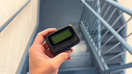 Hospital work pager and technology symbolize efficient communication and coordination between medical professionals, ensuring timely and effective patient care
