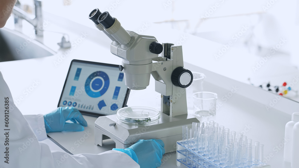 Poster a man observing with a microscope. scientific experiment.
