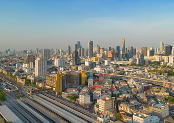 Naklejka na ściany i meble Aerial view of Hua Lamphong or Bangkok Railway Terminal Station with skyscraper buildings in urban city, Bangkok downtown skyline, Thailand. Cars on traffic street road on highways.