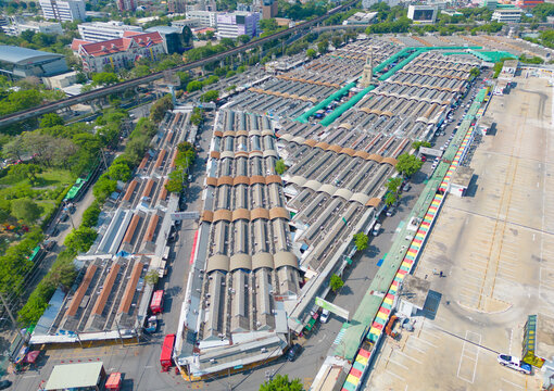 Aerial top view of Chatuchak Weekend street market, the largest market in Bangkok, Thailand, rooftops and parking area. Tents with retail shops on travel on holiday, vacation concept. Tourists area.