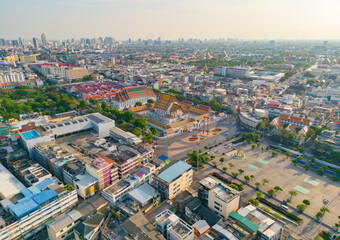 Aerial view of Bangkok Downtown Skyline with temples, Thailand. Financial district and business centers in smart urban city in Asia. Skyscraper and high-rise buildings at sunset.