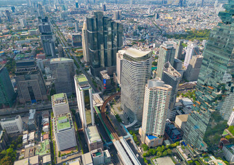 Fototapeta premium Aerial view of Bangkok Downtown Skyline, Thailand. Financial district and business centers in smart urban city in Asia. Skyscraper and high-rise buildings at sunset.