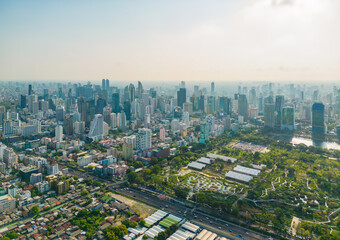 Aerial view of green trees in Lumpini Park, Sathorn district, Bangkok Downtown Skyline. Thailand. Financial district and business center in smart urban city in Asia. Skyscraper buildings