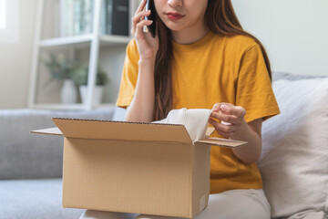 Angry bad, complaint asian young woman opening carton box, received online shopping parcel wrong...