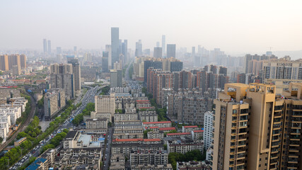 modern complex and traffic along on busy road from daytime to evening photo at high-rise building near junction of Liuyang and Xiangjiang rivers, Changsha, China