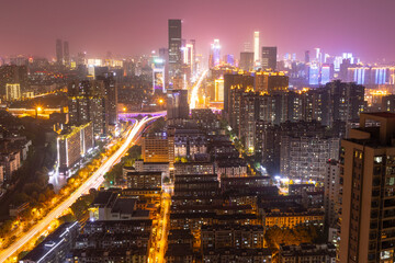 Fototapeta na wymiar night view of modern complex and traffic along on busy road from daytime to evening photo at high-rise building near junction of Liuyang and Xiangjiang rivers, Changsha, China