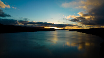 Fototapeta premium sunset over the lake. The setting sun over the lake as the evening sun sets. wonderful sky