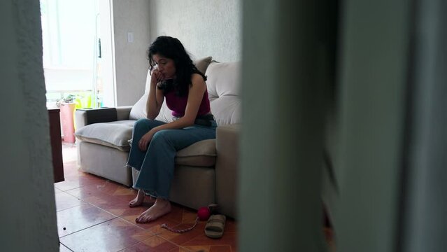 Candid Woman Feeling Anxiety And Worry Seen From Behind Door At Apartment. Female Person In 30s Suffering From Preoccupation