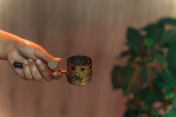 Moxibustion treatment: Traditional Chinese medicine tools for heating acupuncture point therapy. chinese herbal medicine Copper moxibustion burner box with herbal moxa sticks in holistic clinic.