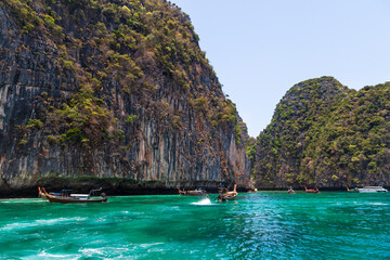 Pier or jetty on phi phi leh island in krabi in thailand near maya bay with boats and tourists on a...