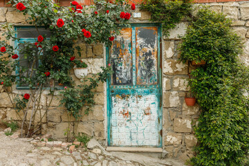 Fototapeta na wymiar painted village house door with roses