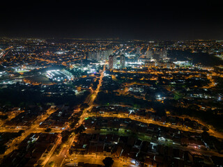 Night aerial photography of the city of Campinas, S&atilde;o Paulo. Dramatic shadows, dark skies and just lights from cars and surrounding buildings. Shopping Unimart and Anhanguera Highway.