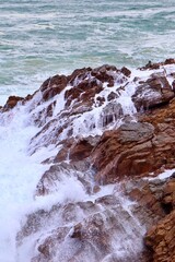 closeup of ocean waves crashing on rocks 