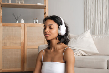 Side view on serene african american woman in headphones meditating. Wellness and zen concept banner with place for text