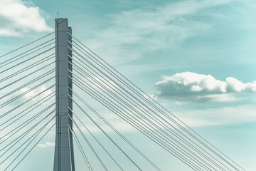 Obraz na płótnie Canvas Close up detail with a cable stayed suspension bridge against the blue sky