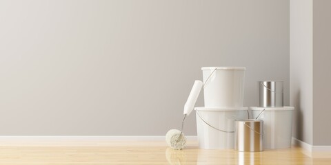 Paint roller leaning against white paint buckets and paint cans in empty room with grey wall background, home improvement, renovation or construction work concept with copy space