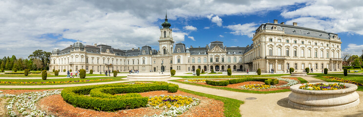 Fototapeta na wymiar Keszthely, Beautiful Baroque Palace of the Festetics family (Helikon Palace Museum) Historical architecture in Hungary Panorama blue sky with picturesque clouds, spring gardens. Keszthely 30.04.2023