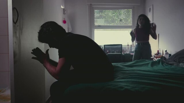Couple in Turmoil: Relationship Break-up with Male Partner Feeling Overwhelmed and Female Partner Expressing Anger in Bedroom Scene