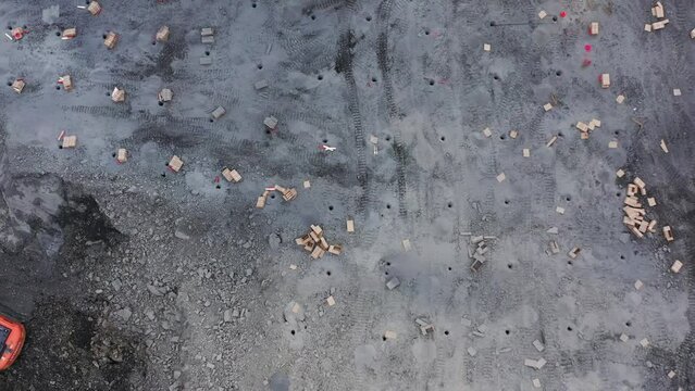 drone flies over a mined stone quarry explosive holes are visible
