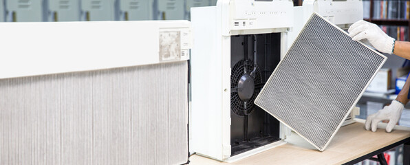 Technician open cover to fix and holding dirty and dust air purifier filter for removing and...