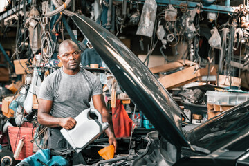 Auto mechanic diagnose and troubleshoots with tools and equipment. Polishing car, fixing braking and steering systems. Measuring oil levels with oil gauge stick and then pouring or changing it.