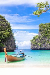 The Thai traditional wooden longtail boat and beautiful beach in Phuket province, Thailand. - obrazy, fototapety, plakaty