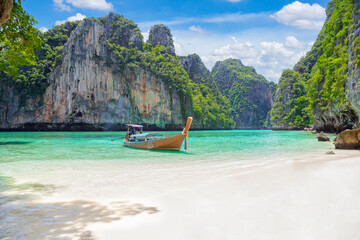 The Thai traditional wooden longtail boat and beautiful beach in Phuket province, Thailand.