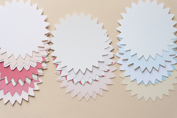 various piles of stylized or abstract representations of a flower or floral emblem or badge with...