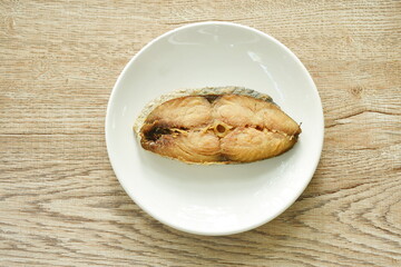 chop fried salty dry Indo-Pacific king mackerel fish on plate 