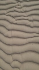 Fototapeta na wymiar sand ripple texture on beach