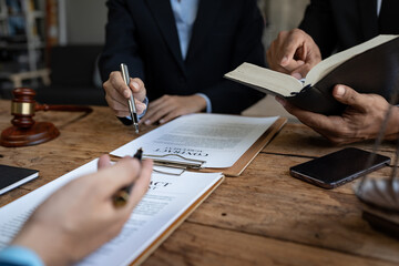 Consultation and meeting of professional male lawyers and businesswomen working and discussing contracts at law firm. concept of law judge with scales of justice.