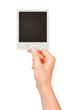 One instant photo in hand isolated on white background.