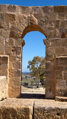 Outer wall with an arched door in the amphitheater in the Roman ruins at Uthina, outside of Tunis, Tunisia