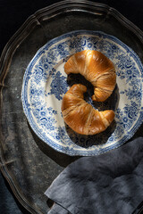 Croissants on a silver vintage tray.  Breakfast  on a sunny morning..
