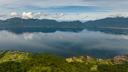 Top view of beautiful blue Maninjau lake and farmland in a volcano crater. Sumatra, Indonesia.