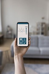 Smartphone screen with smart home electronic automation app, software interface for control light, music, monitoring climate, thermostat indoors. Close up of cellphone in apartment interior