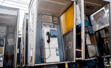 Old and dirty street phones at the city landfill