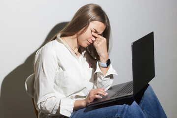 tired girl with laptop on white background