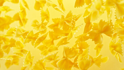 Dry farfalle pasta flying in the air.