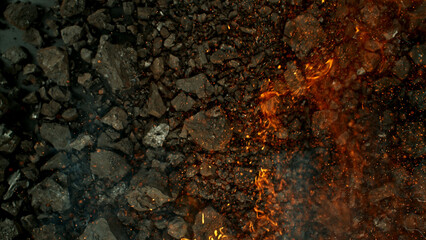 Burning coal with fire, top view shot.