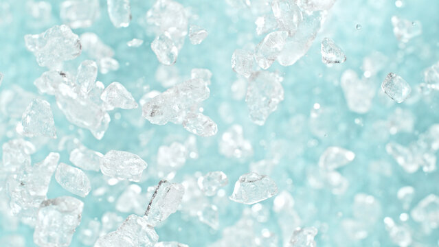 Freeze motion of flying crushed ice isolated on blue background.