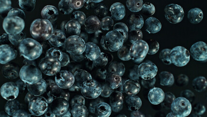 Top shot of blueberries flying up in the air.