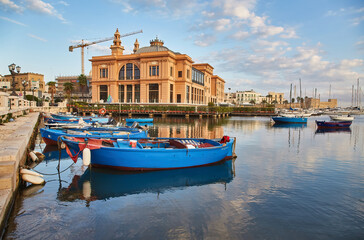 Margherita Theater and fishing boats in old harbor of Bari, Italy. Bari is the capital city of the...