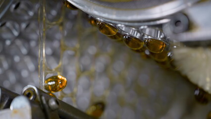 Gelatin capsules in the production of vitamins and medicines. Slow motion