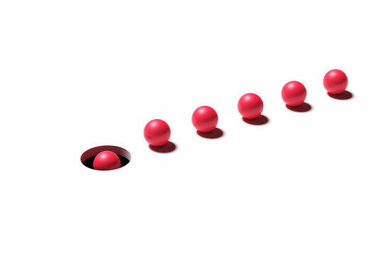 Bad leadership and blind conformity concepts. Red balls in a row following the leader towards the dark hole.