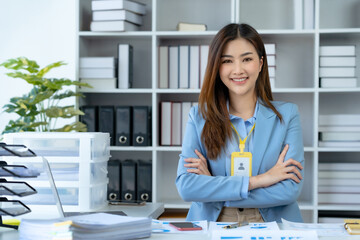 Confident Asian businesswoman arms crossed thinking new idea at office. Looking at camera.