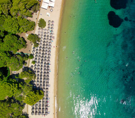 Overhead aerial view of beach umbrellas along a beautiful beach